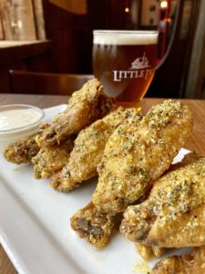 Little Pub's World Famous LemonyPeppery Wings: Crispy wings tossed in lemon pepper spiked garlic butter and served with a side of buttermilk ranch dip