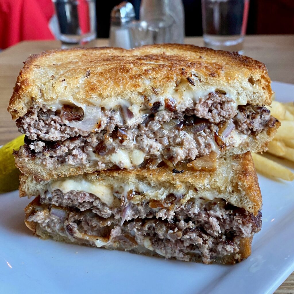 Pub Patty Melt _ Twin 4oz burger patties, American cheese, chopped bacon, steamed onions and little pub secret sauce® all grilled between thick NY rye bread