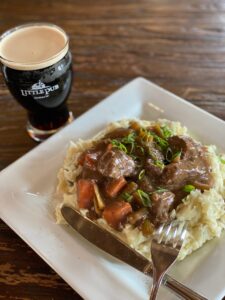 Ribsticker Stew Beef tenderloin tips, carrots, and celery simmered in a rich French onion gravy and served over creamy, goat cheese loaded, smashed potatoes