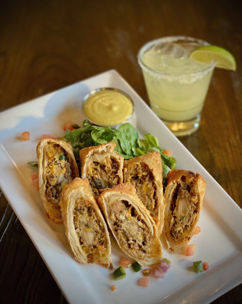 Crispy egg rolls loaded with fork shredded coconut milk simmered Caribbean jerk spiced chicken, cheddar jack cheese, and pico de gallo. Served with a curry honey aioli dip