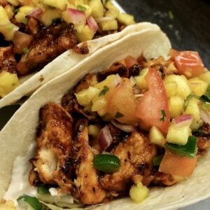 Little Puib Caribbean Fish Tacos Caribbean Jerk spiced tilapia, shredded cabbage, pineapple pico, guacamole and a drizzle of honey curry aioli in soft flour tortillas
